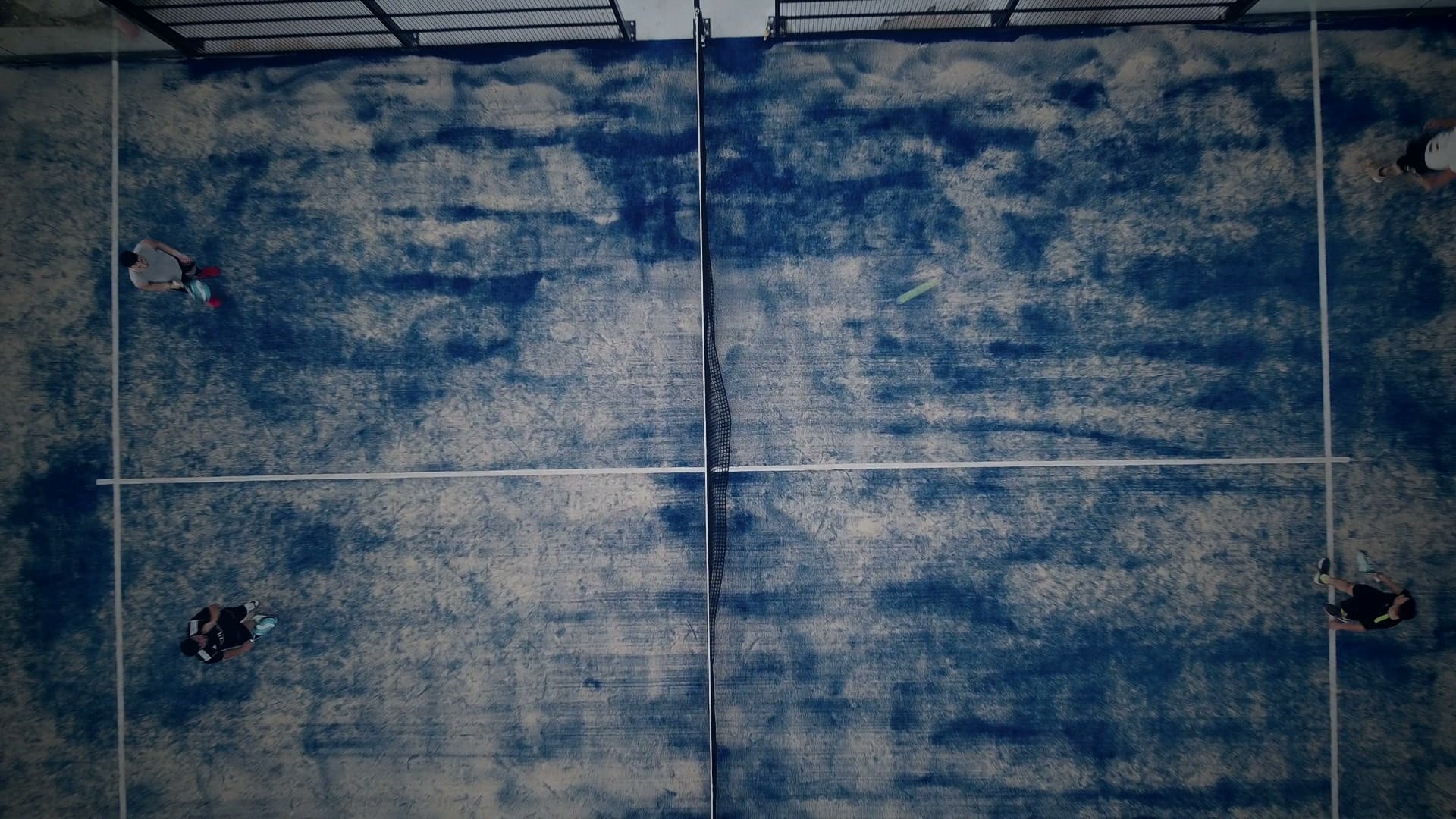 Aerial view looking straight down onto a blue padel court