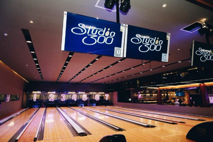 Bowling lanes under Studio 300 signage